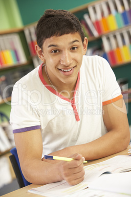 Teenage Male Student In Working In Classroom