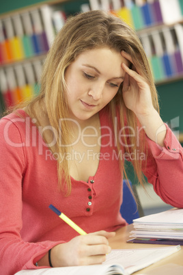 Teenage Female Student In Working In Classroom