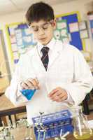 Male Teenage Student In Science Class With Experiment