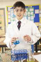 Male Teenage Student In Science Class With Experiment