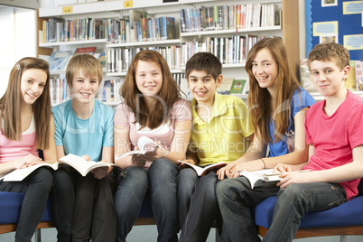 Teenage Students In Library Reading Books