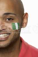 Young Male Sports Fan With Nigerian Flag Painted On Face