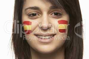 Young Female Sports Fan With Spanish Flag Painted On Face