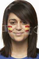 Young Female Sports Fan With Spanish Flag Painted On Face