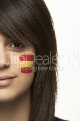 Young Female Sports Fan With Spanish Flag Painted On Face