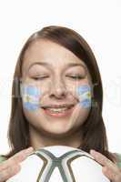 Young Female Football Fan With Argentinian Flag Painted On Face