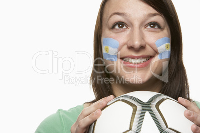 Young Female Football Fan With Argentinian Flag Painted On Face