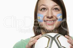 Young Female Football Fan With Argentinian Flag Painted On Face