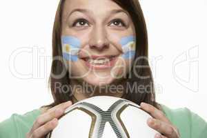 Young Female Football Fan With Argentinian Flag Painted On Face