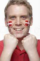 Young Male Sports Fan With Danish Flag Painted On Face