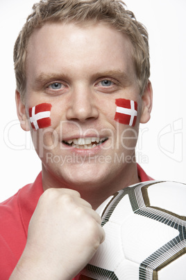 Young Male Football Fan With Danish Flag Painted On Face