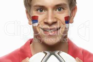 Young Male Football Fan With Serbian Flag Painted On Face