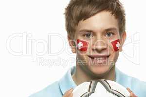 Young Male Football Fan With Swiss Flag Painted On Face