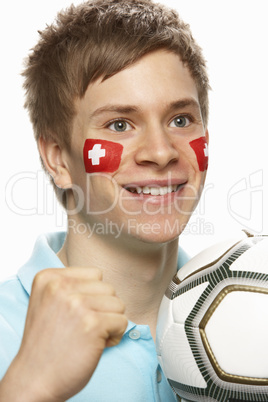 Young Male Football Fan With Swiss Flag Painted On Face