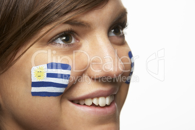 Young Female Sports Fan With Uruguayan Flag Painted On Face