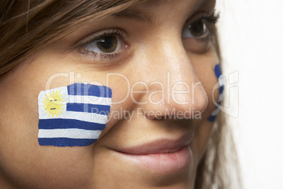 Young Female Sports Fan With Uruguayan Flag Painted On Face