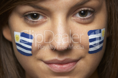 Young Female Sports Fan With Uruguayan Flag Painted On Face