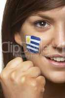 Young Female Sports Fan With Uruguayan Flag Painted On Face