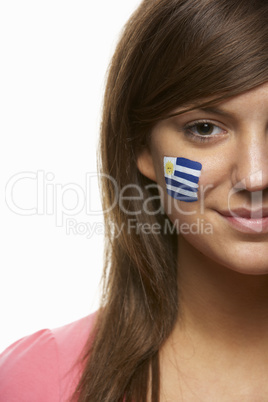 Young Female Sports Fan With Uruguayan Flag Painted On Face