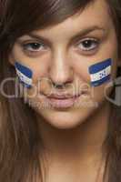 Young Female Sports Fan With Honduran Flag Painted On Face