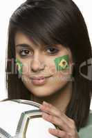 Young Female Football Fan With Brazilian Flag Painted On Face