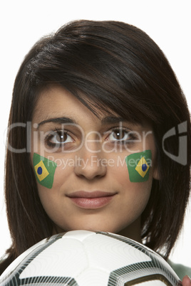 Young Female Football Fan With Brazilian Flag Painted On Face