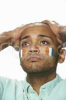 Disappointed Young Male Sports Fan With Ivory Coast Flag Painted