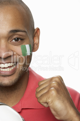 Young Male Football Fan With Nigerian Flag Painted On Face