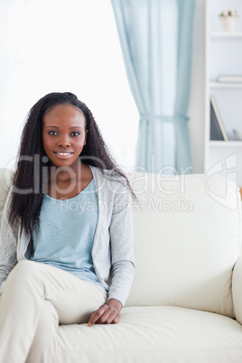 Young woman sitting on sofa