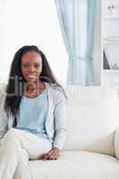 Young woman sitting on sofa