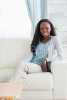 Smiling woman leaning against armrest