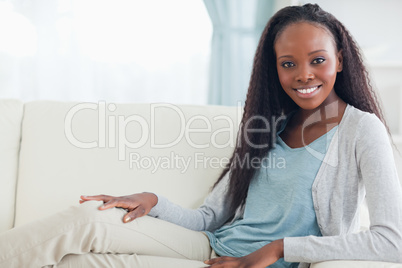 Smiling woman relaxing on sofa