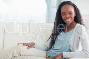 Smiling woman relaxing on sofa