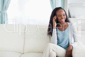 Woman phoning on sofa