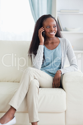 Close up of woman with cellphone on sofa