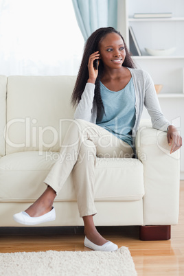 Woman with mobile phone on couch