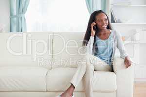 Woman with cellphone on couch
