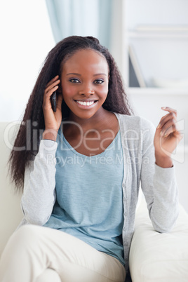 Close up of woman with mobile phone on the sofa