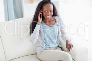 Woman with her cellphone on the sofa