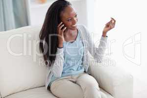 Woman on the sofa talking on the phone
