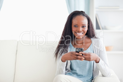 Woman in living room with her phone