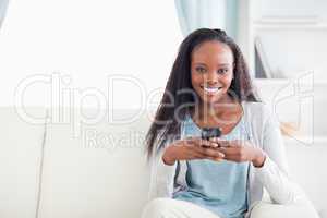 Woman in living room with her phone