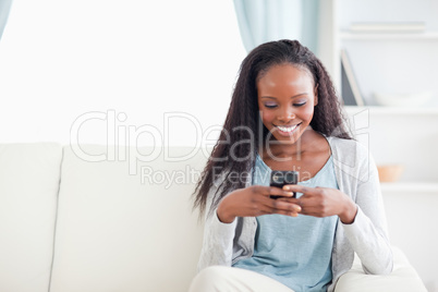 Woman in living room reading text message