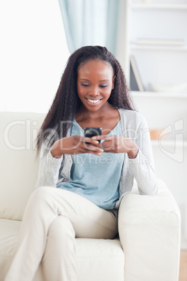 Woman in living room text messaging