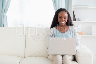 Woman in living room with laptop
