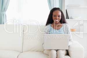 Woman in living room with laptop