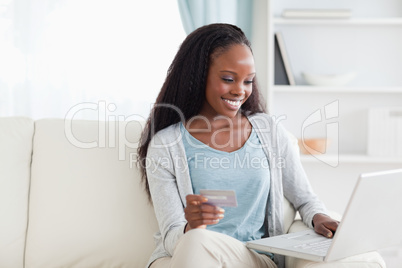 Woman in living room shopping online