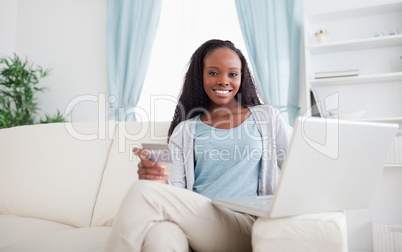 Woman shopping online while sitting on chouch
