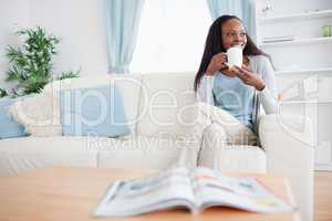 Woman drinking coffee on the sofa