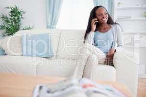 Woman on the phone while sitting on sofa